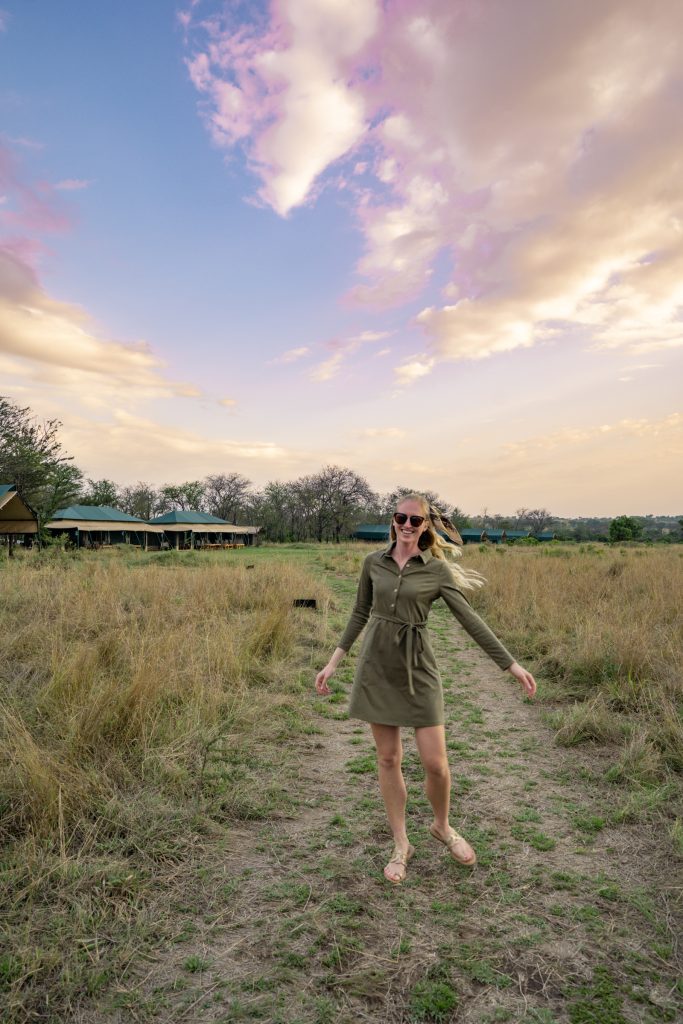 twirling in an army green dress in Nasikia Mobile Migration Camp in Northern Tanzania - what to wear on safari for women for evening time to look cute